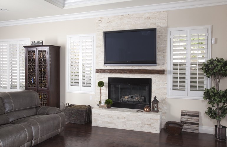 White plantation shutters in a Atlanta living room with solid hardwood floors.